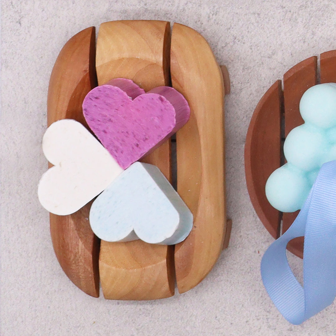 Wooden rectangular soap dish with soap on the top, drainage slats